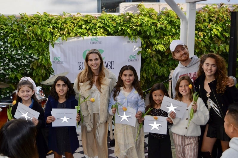 Young students with their certificates at an OC Room2Stage showcase